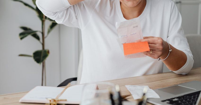 IT Costs - Woman at Desk Looking at Receipt and Scratching Her Head