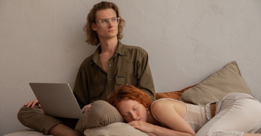 Remote Work - Woman Sleeping while Lying on a Man's Lap