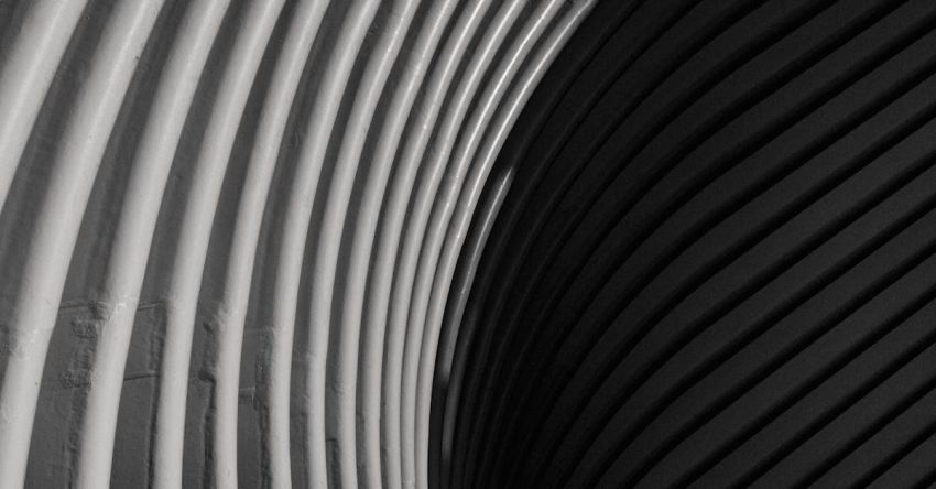 Full-Stack Development - Black and white of exterior of contemporary structure with curve lines in city